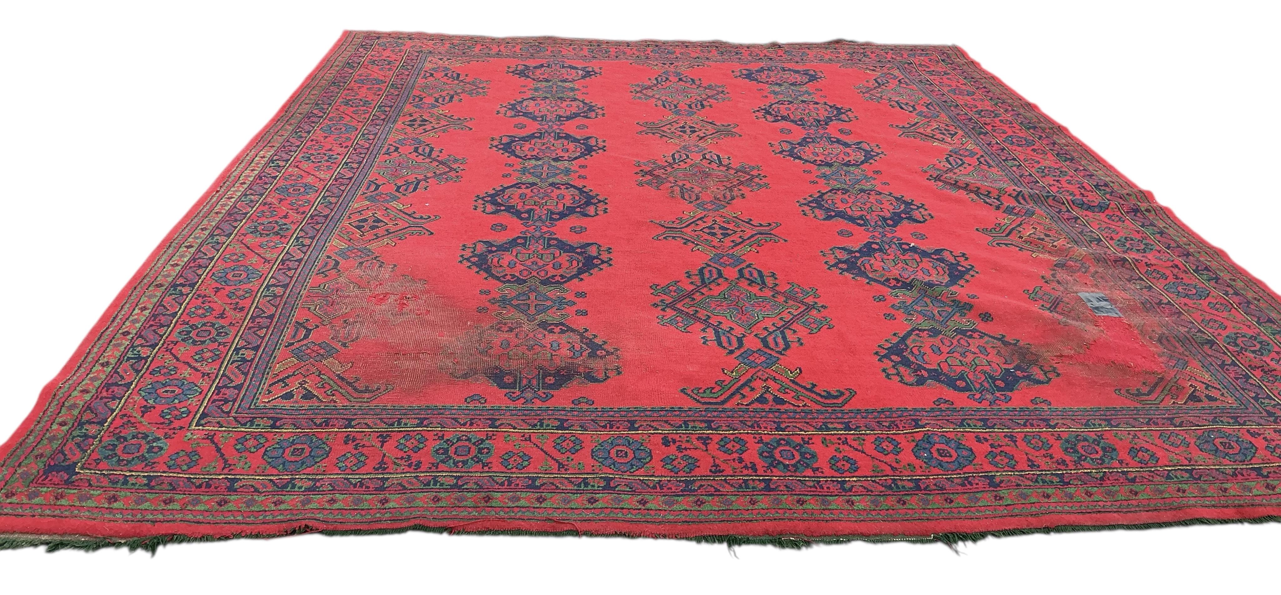 An early 20th century Afghan red ground carpet, 445 x 375cm